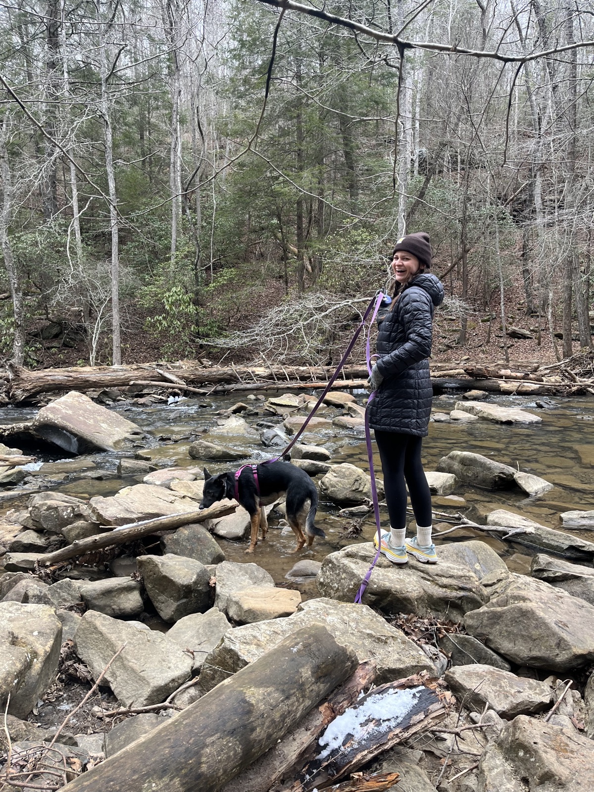 Abigail hiking a creek with Birdie