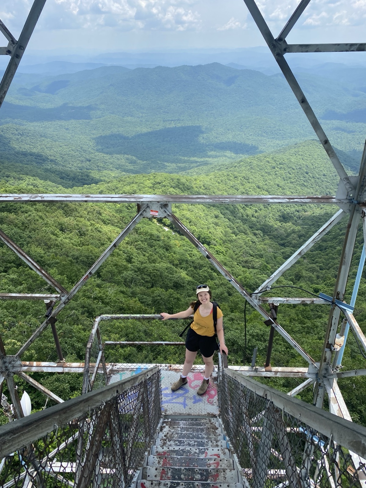 Amelia at the top of a fire tower over the Blue Ridge