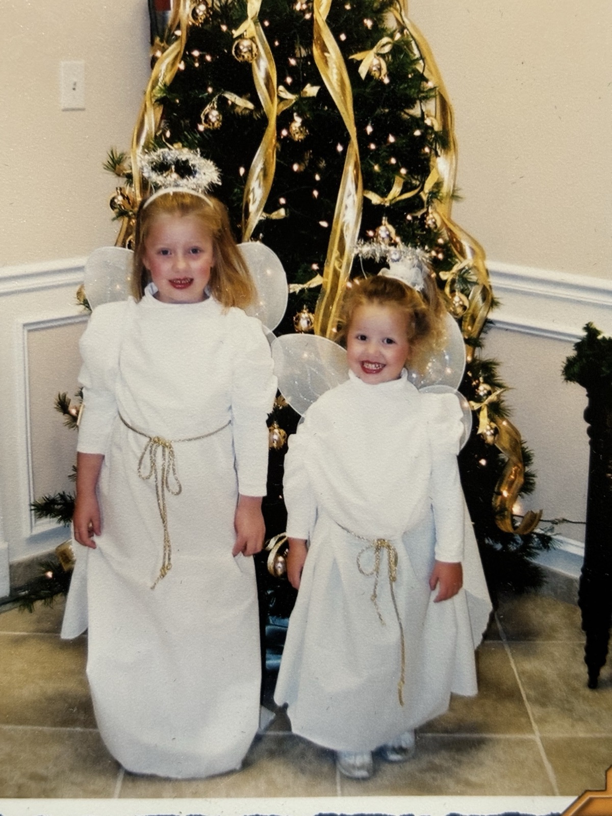 Amelia and her sister dressed as Christmas angels