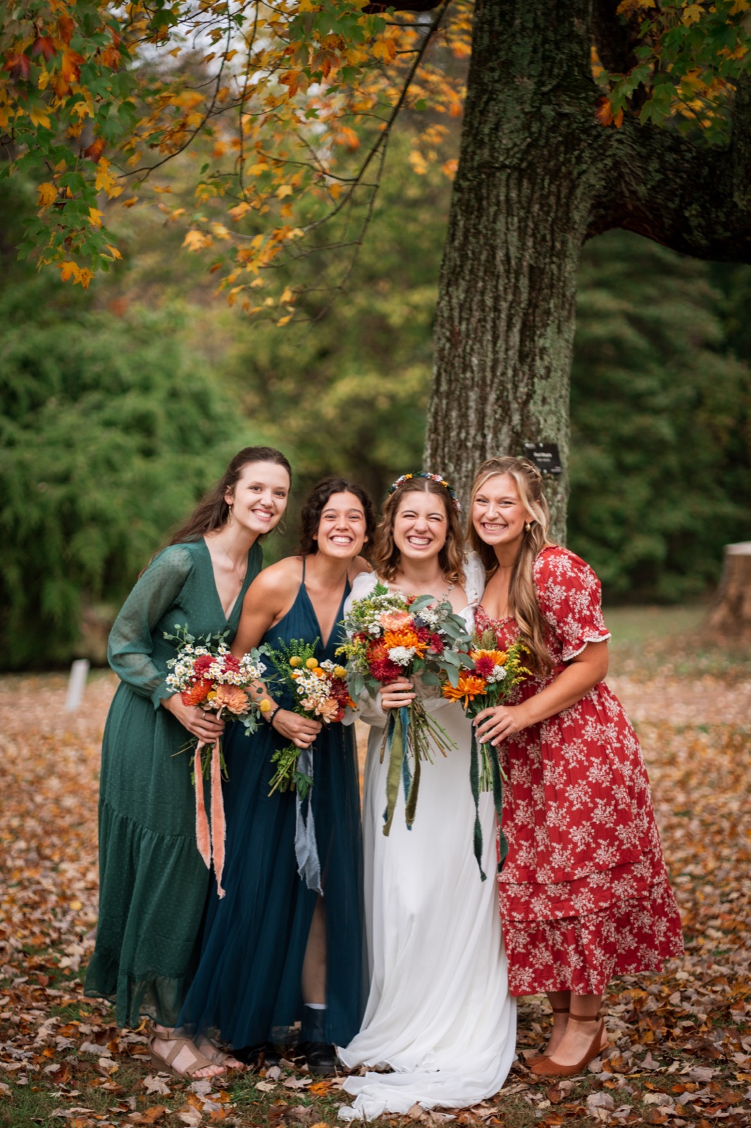 Amelia with friends at a fall wedding