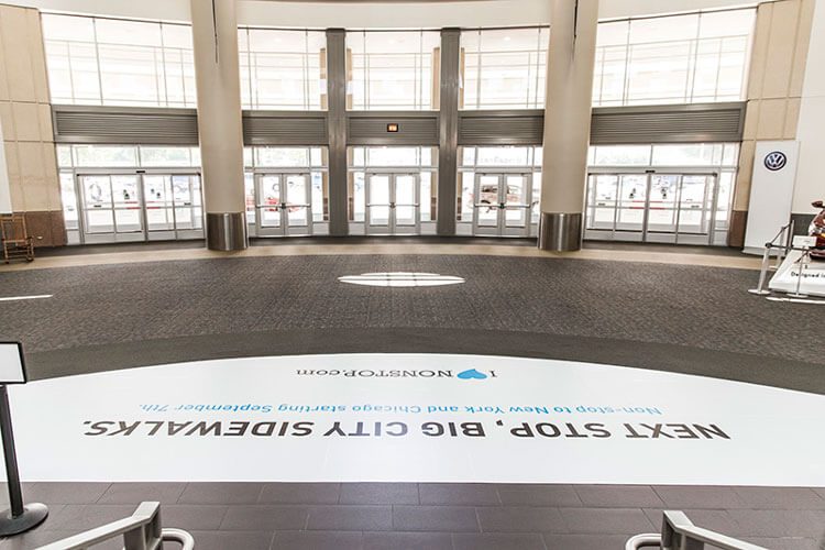 Floor graphic in the terminal rotunda reading Next Stop, Big City Sidewalks