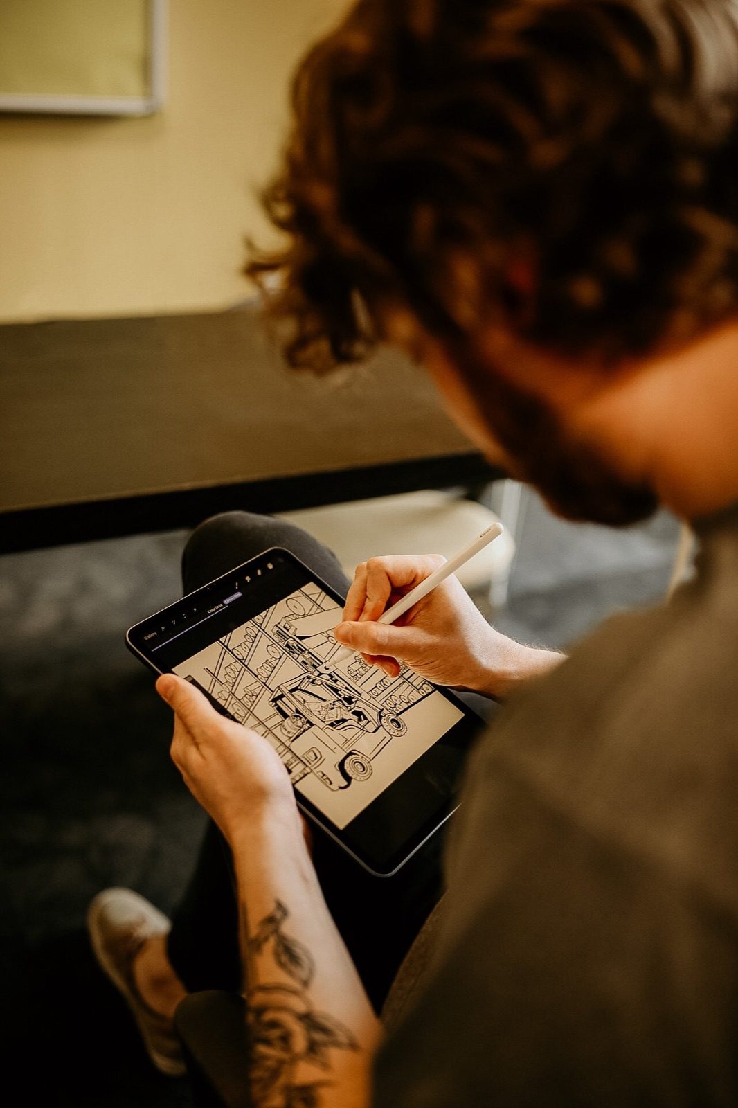 Someone sketching a design on a tablet with a stylus