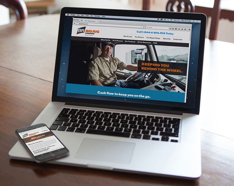 Laptop and phone showing the Big Rig Lending website, Keeping you behind the wheel