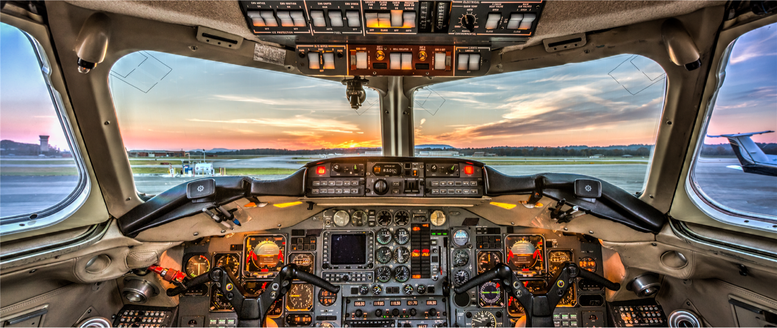 View from an airliner cockpit at sunset