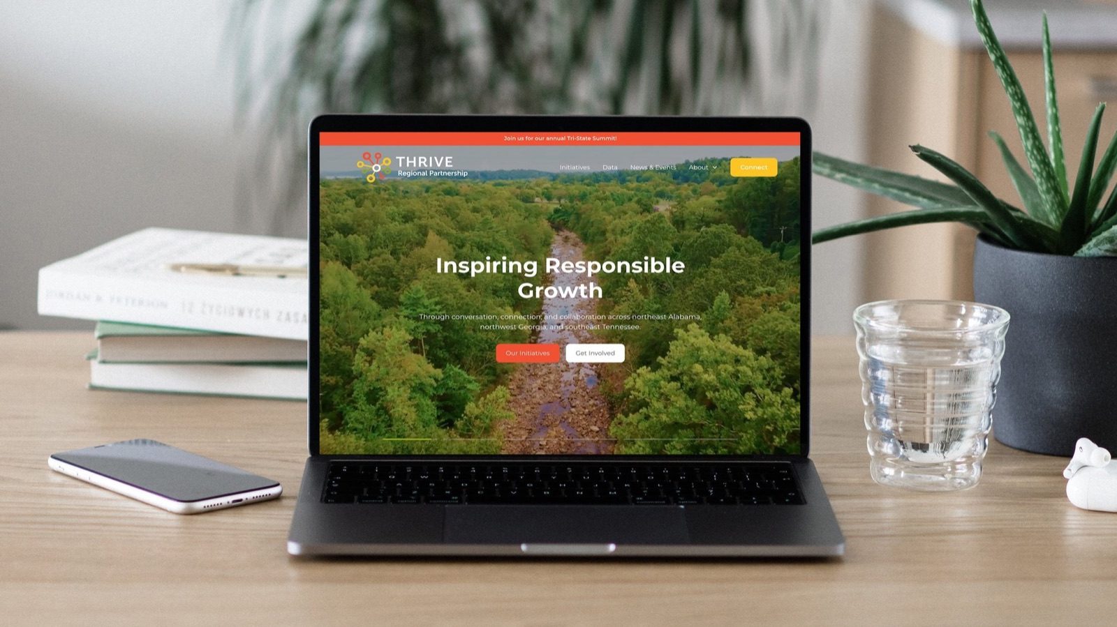 The redesigned Thrive Regional Partnership site on a laptop, headlined 'Inspiring Responsible Growth'
