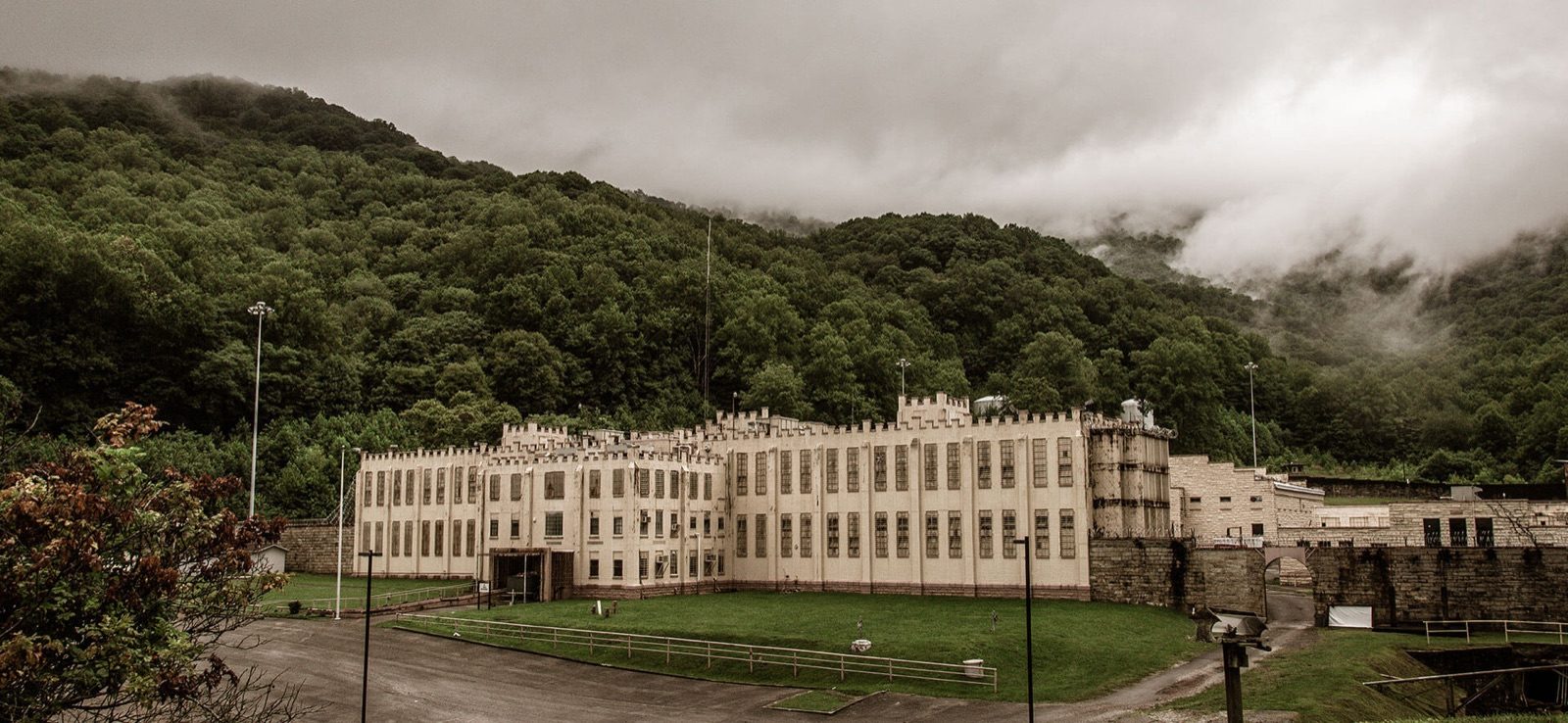 Brushy Mountain State Penitentiary beneath low clouds and forested hills