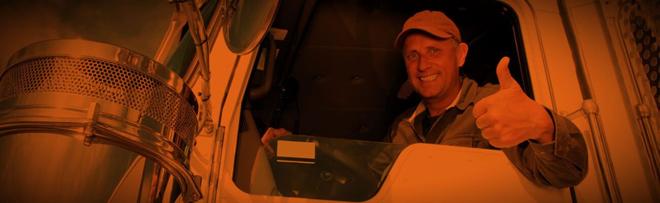 Truck driver giving a thumbs up from the cab window