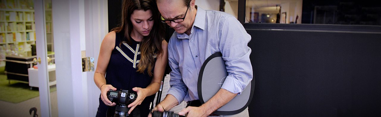 Photographer showing a model an image on the camera screen