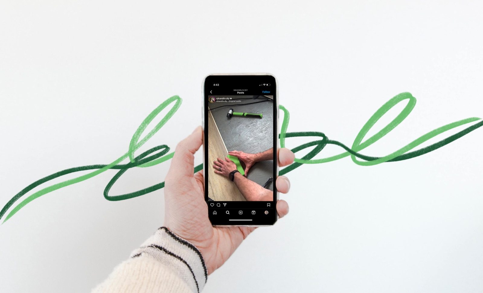 Hand holding a phone to photograph a green ribbon sculpture on a white wall