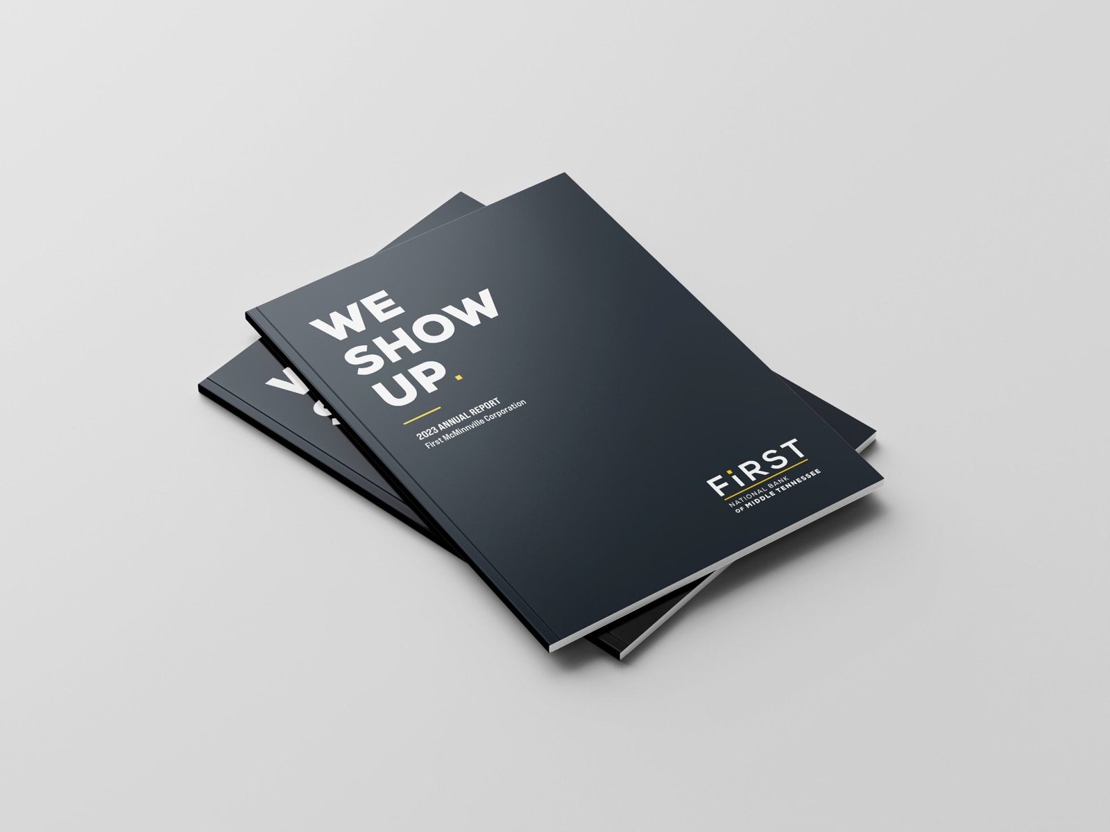 Two copies of the First annual report, a dark cover reading 'We show up'