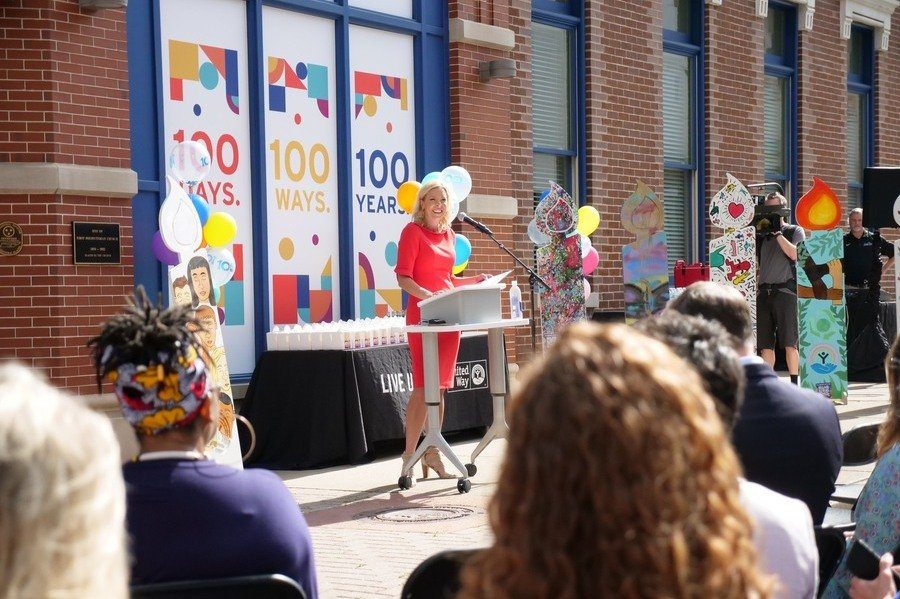 A speaker at a podium outside the United Way building during the campaign kick-off