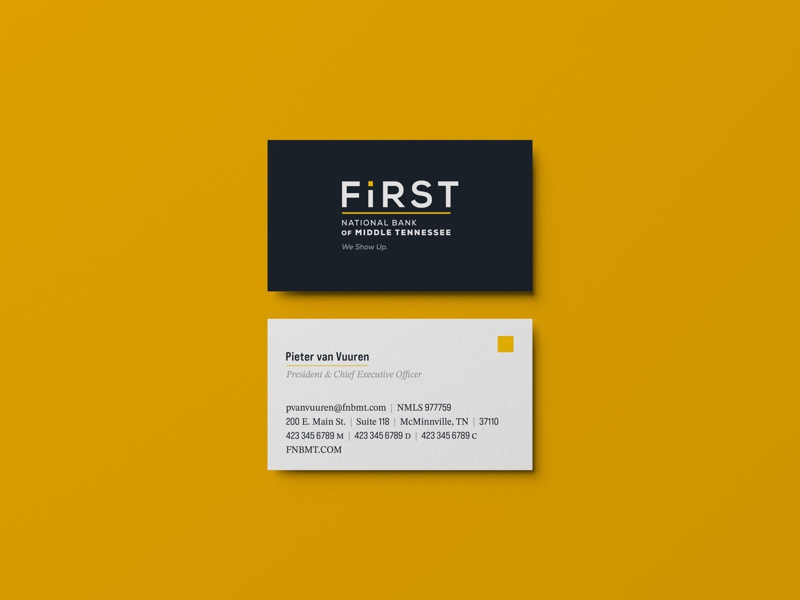 A First business card in dark navy and white on a yellow background