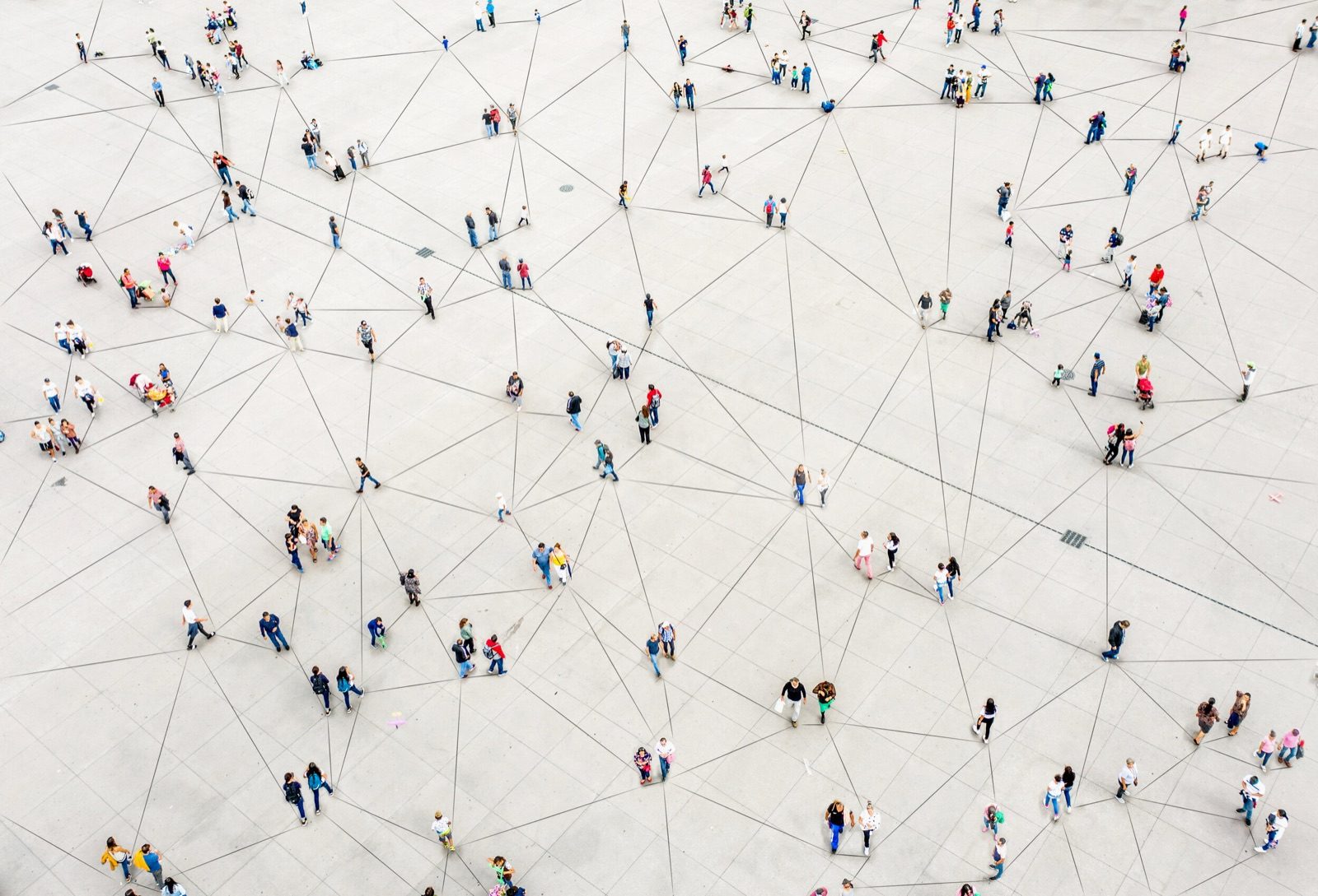 Aerial view of people standing on a white floor connected by drawn lines