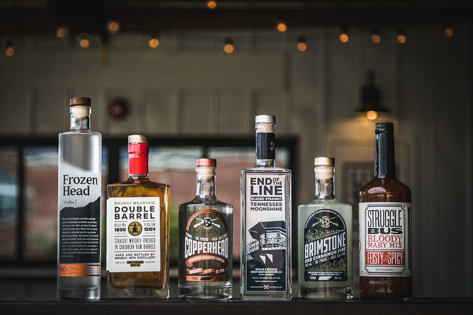 Brushy Mountain Distillery bottles lined up on a bar, including Frozen Head, Double Barrel and End of the Line