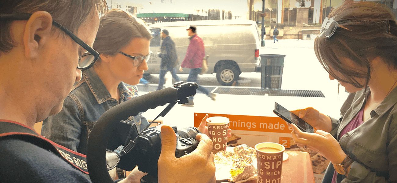 Photographer shooting with a camera on a busy street