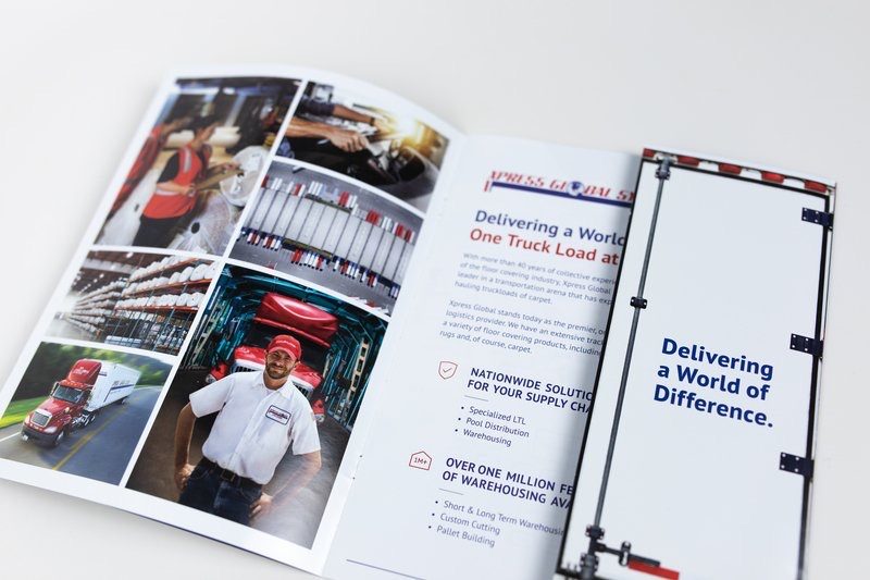 XGS brochure spread with photos of trucks and staff and the headline Delivering a World of Difference