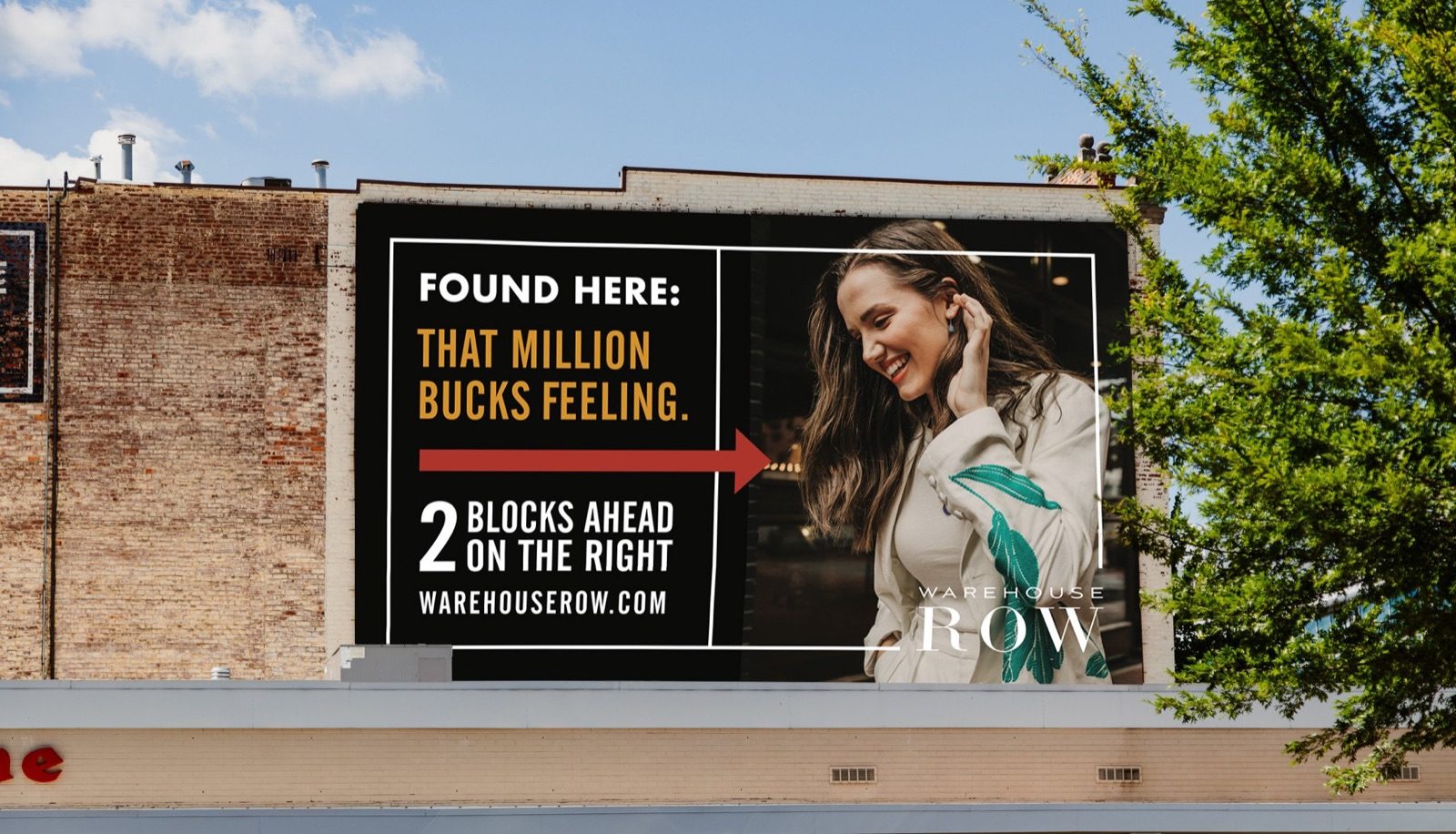 Warehouse Row billboard on a brick building: Found here, that million bucks feeling, 2 blocks ahead on the right