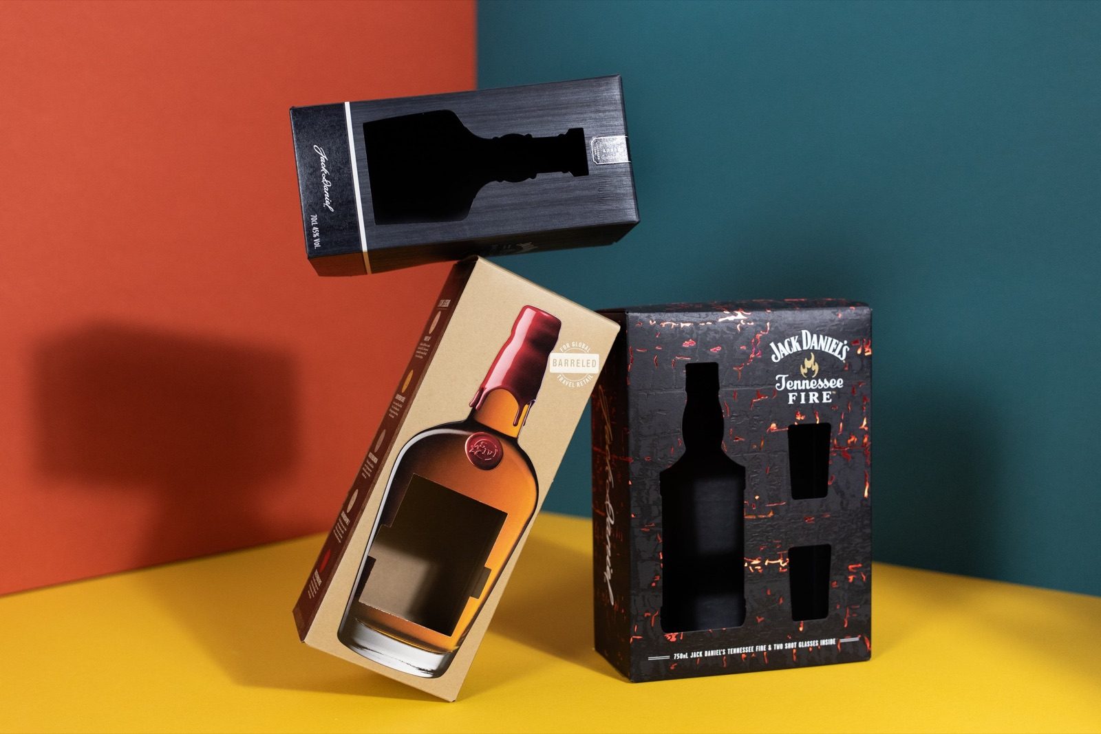 A whiskey bottle gift box shown flat, folded, and packed with a bottle and glass