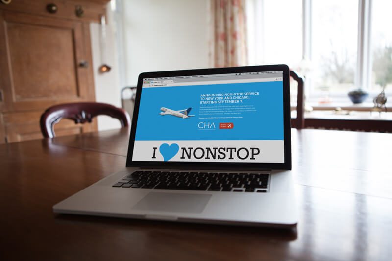 Laptop showing the I heart nonstop microsite on a wooden table