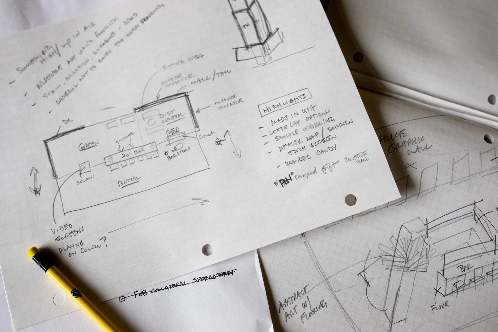 Pencil sketches and handwritten notes for a trade show booth layout