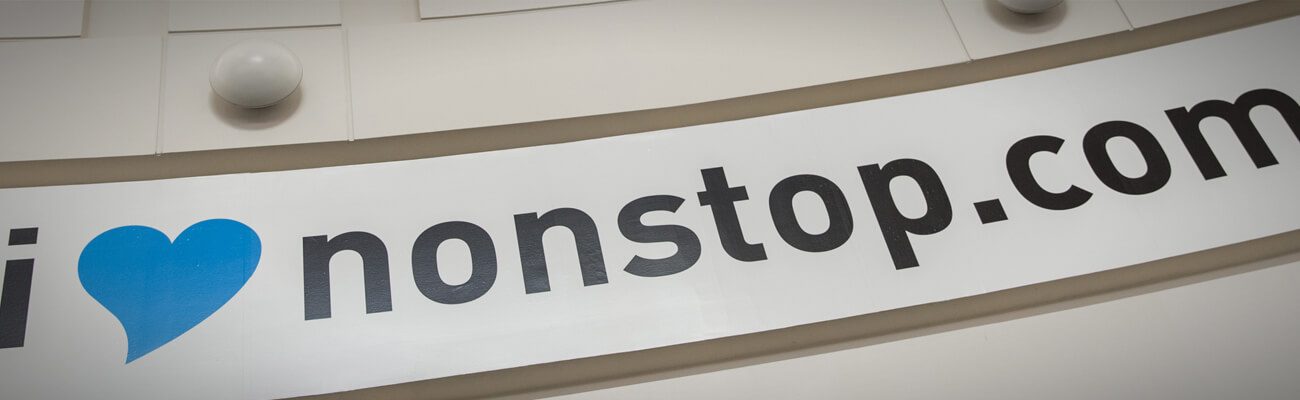 iheartnonstop.com lettering on a curved airport wall