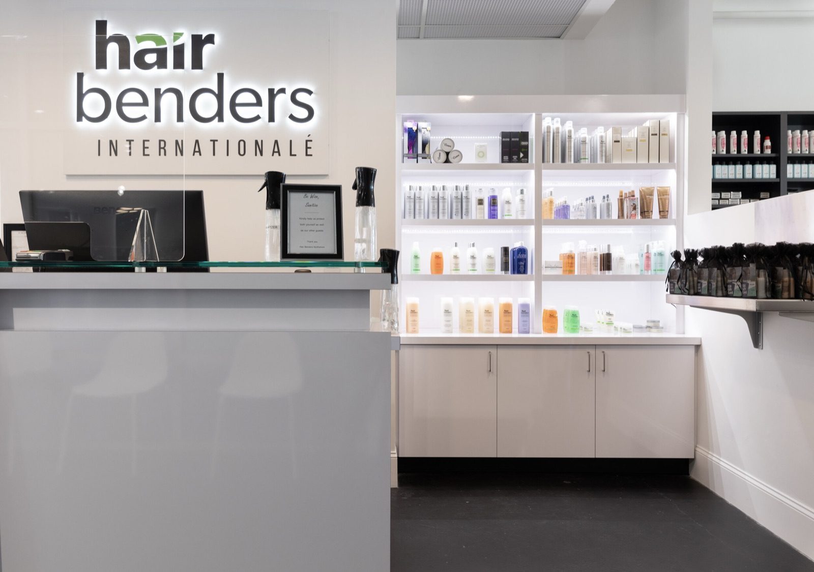 The Hair Benders Internationale salon reception, with product shelves behind the desk
