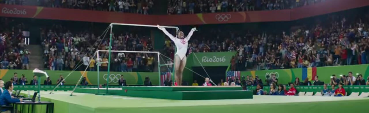 Gymnast on the balance beam in front of a stadium crowd