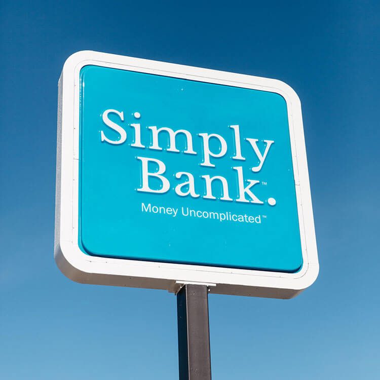 Simply Bank sign, Money Uncomplicated, against a blue sky