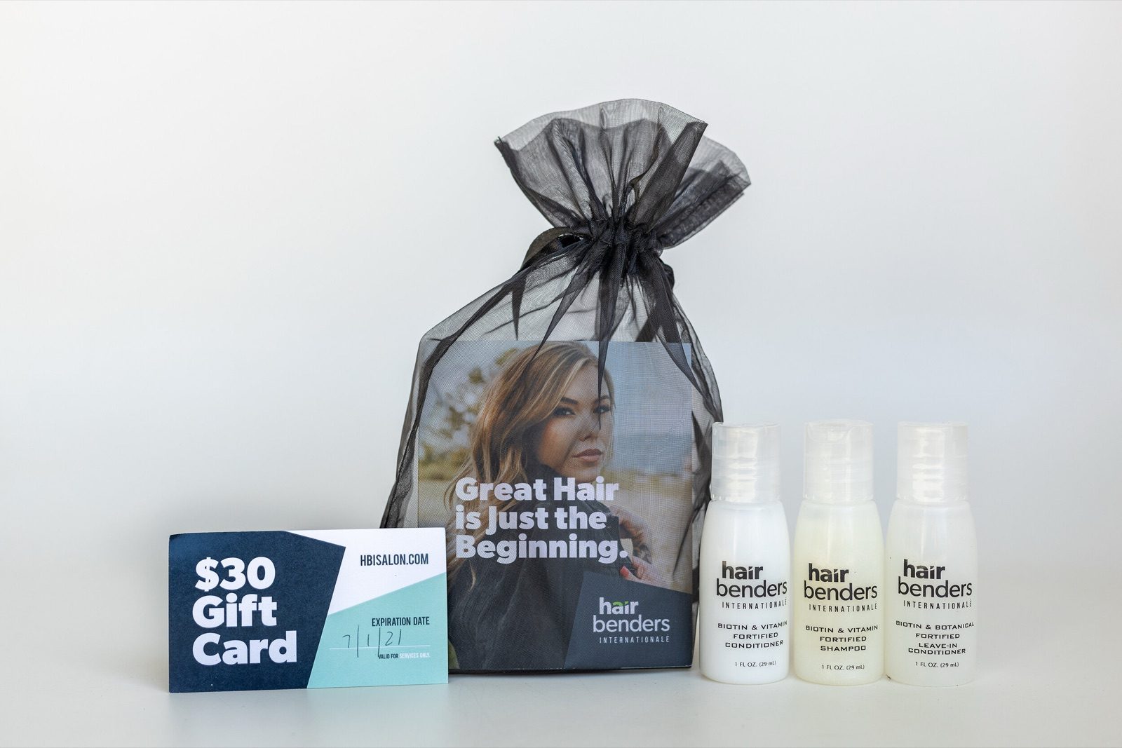 A Hair Benders gift bag with three product bottles and a thirty dollar gift card