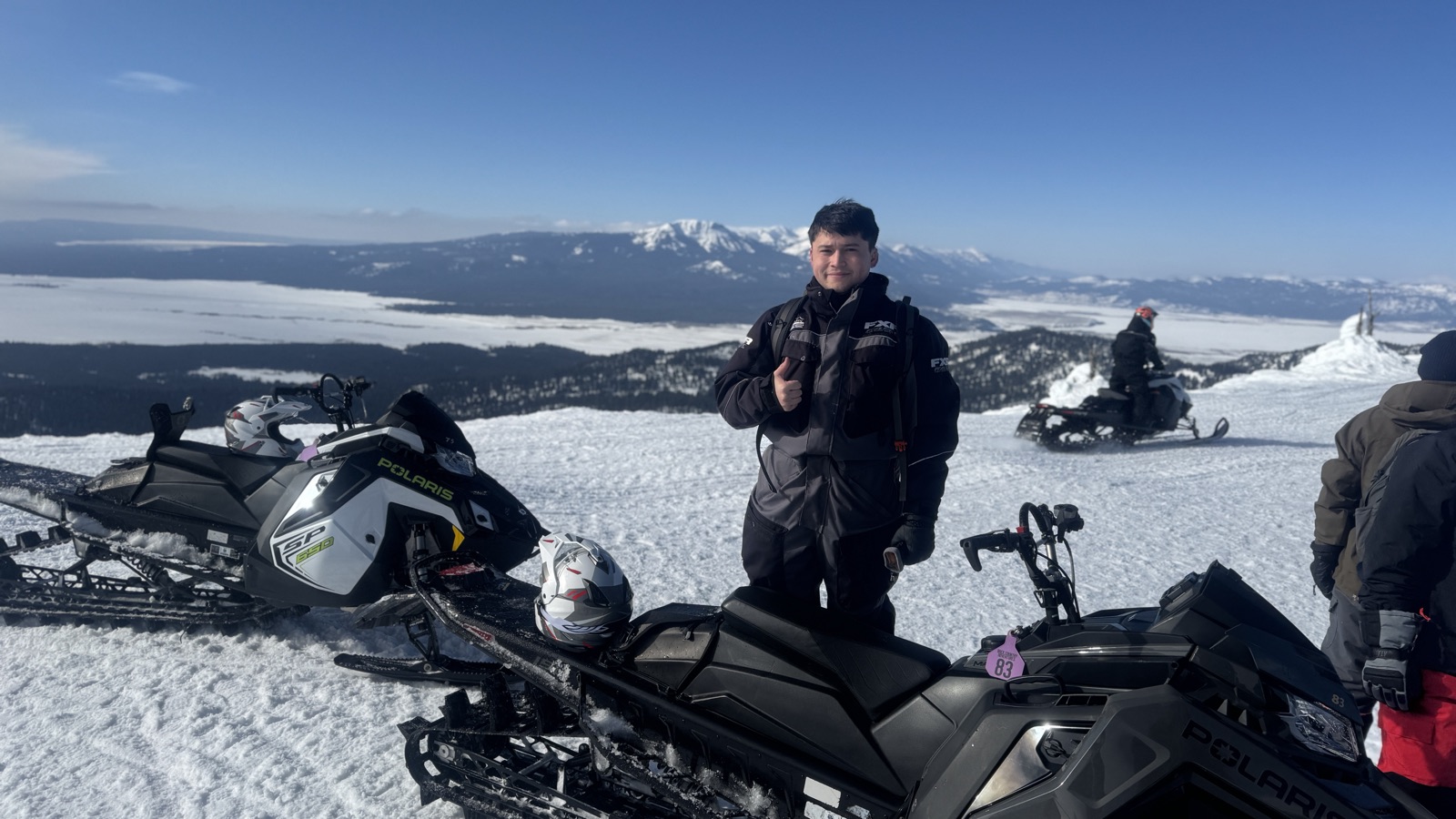 Bob snowmobiling above the treeline