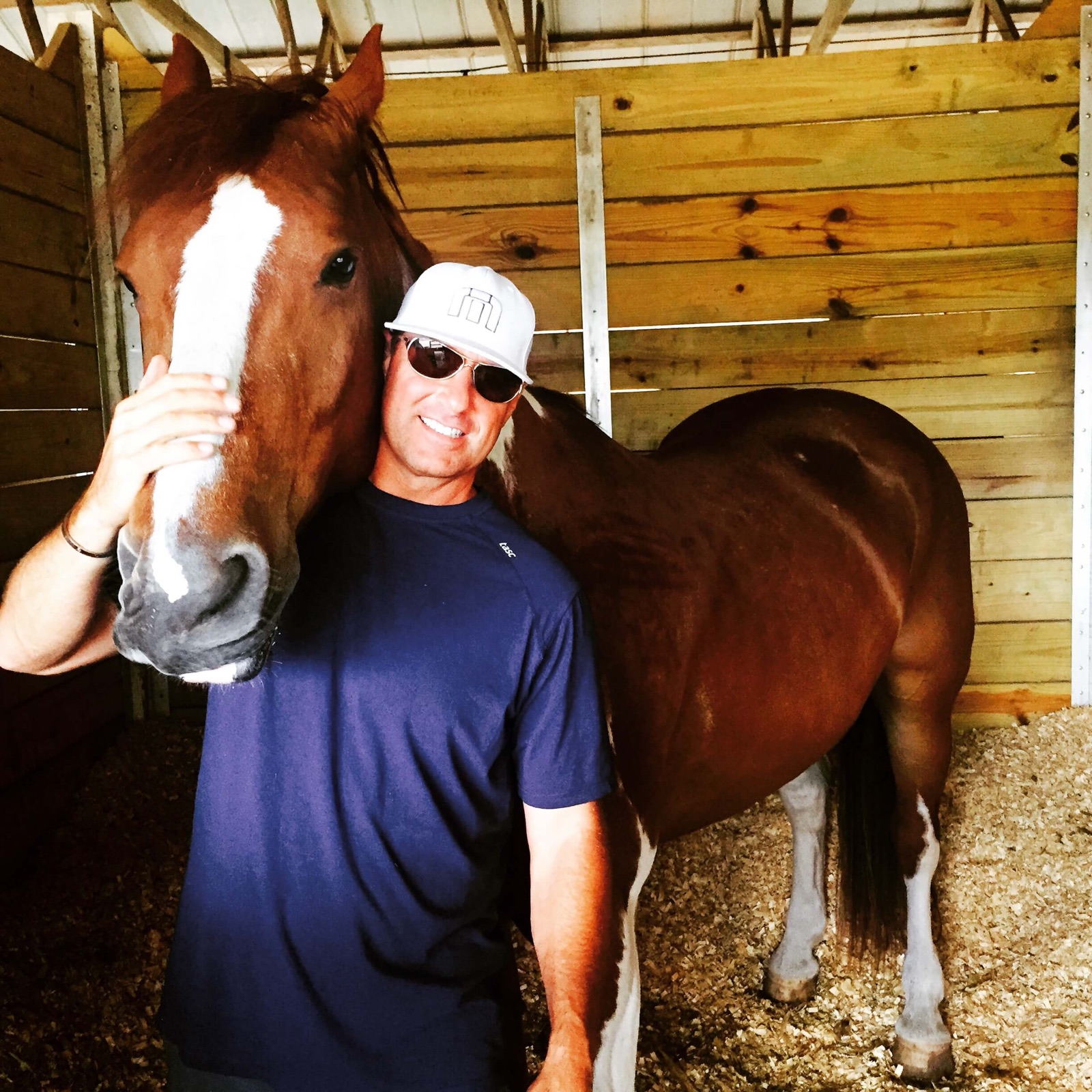 Eric with his horse in the barn