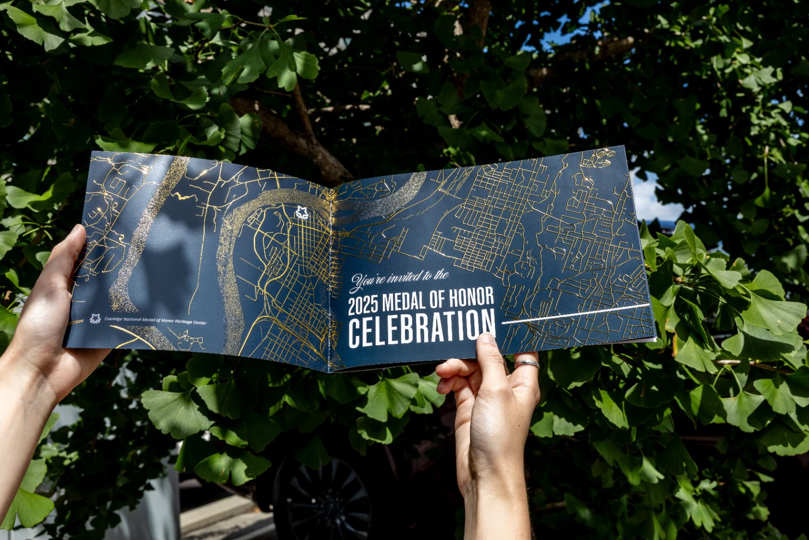 Foil-stamped invitation folder inside the box