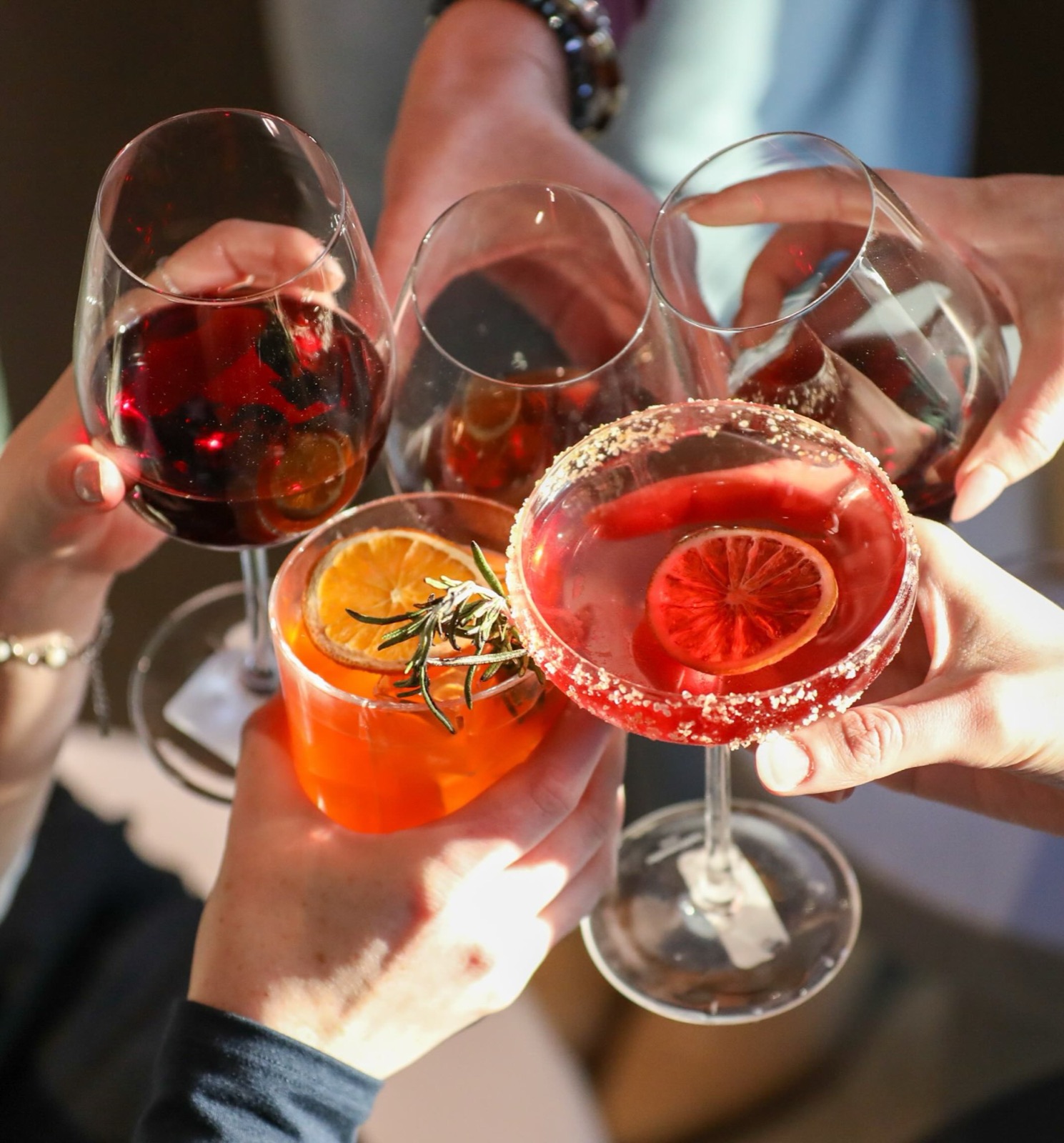 Guests toasting cocktails at Nomia