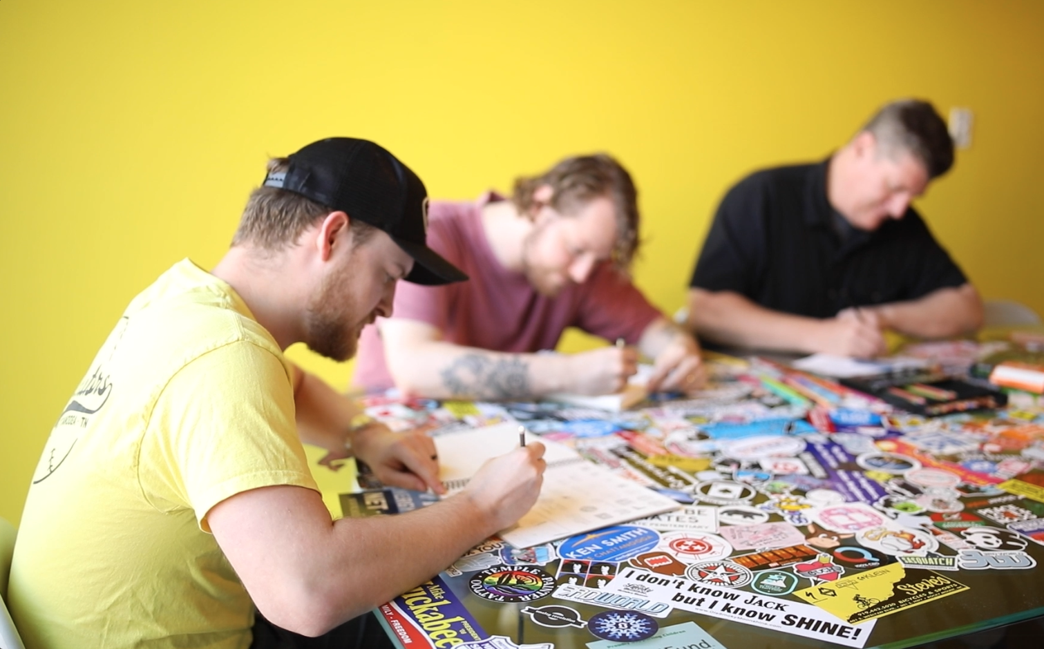 Team sketching around the sticker table