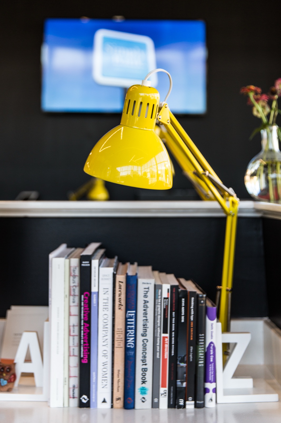 Desk lamp and the studio library shelf