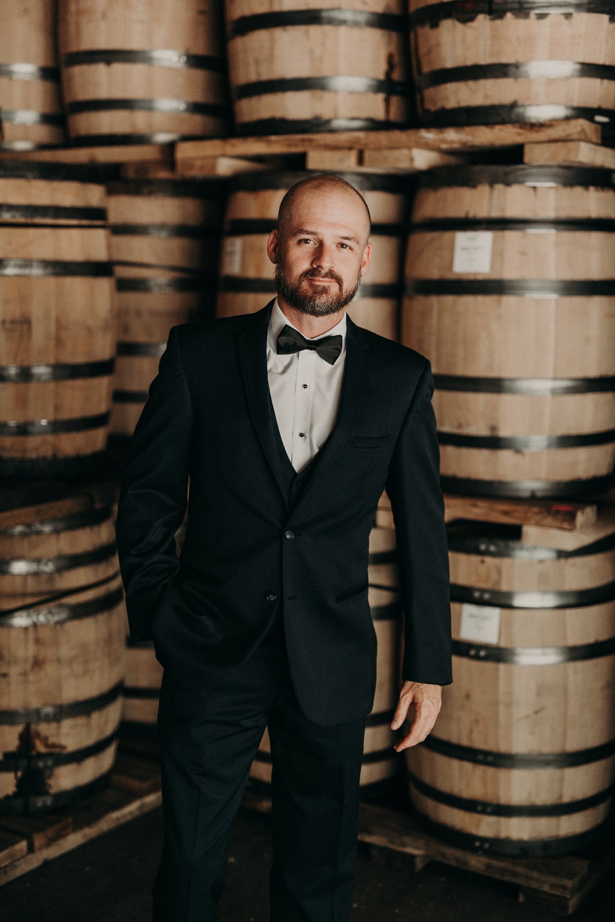 Aaron in a distillery barrel room