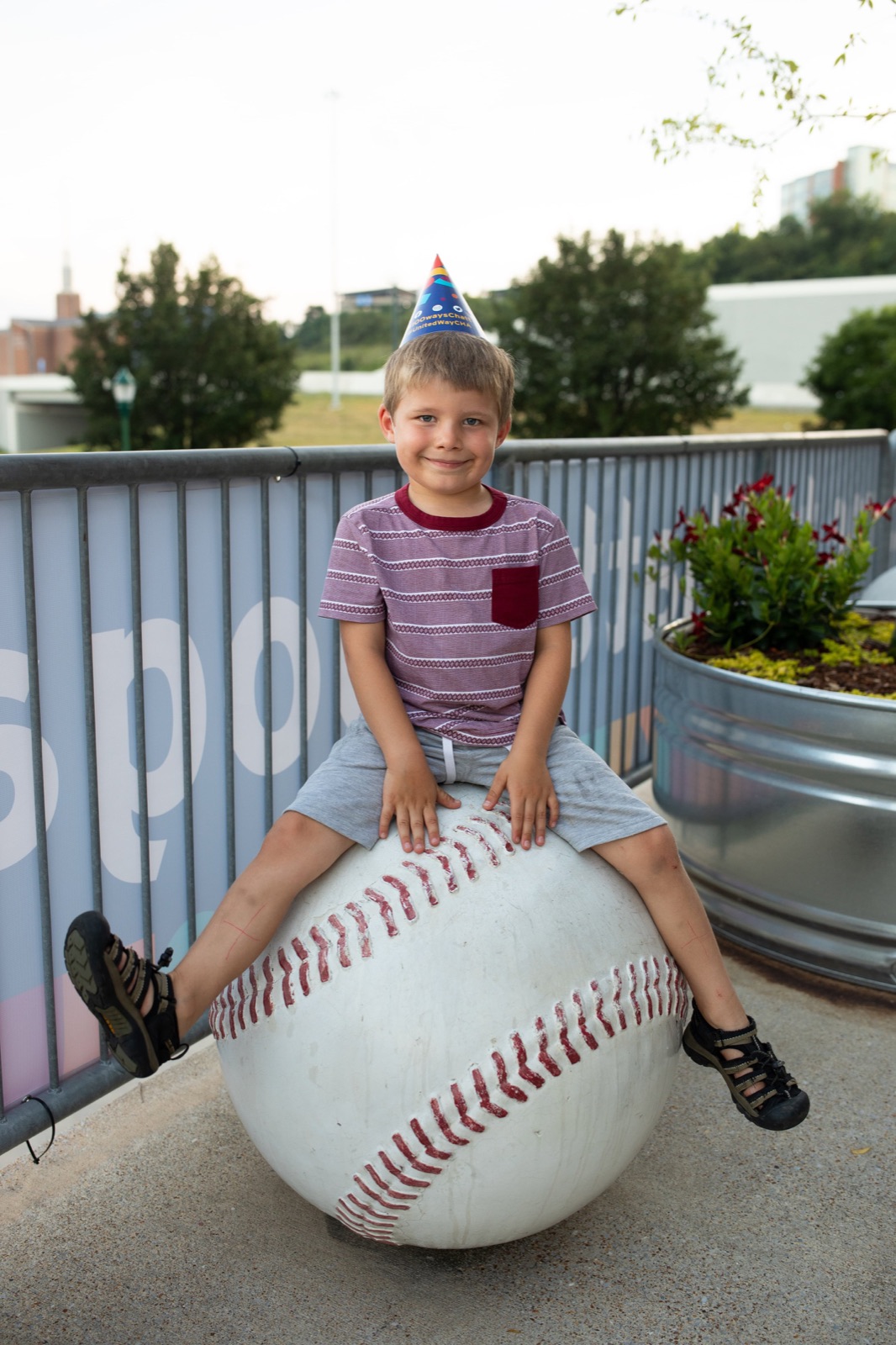Young fan in a birthday hat at the ballpark